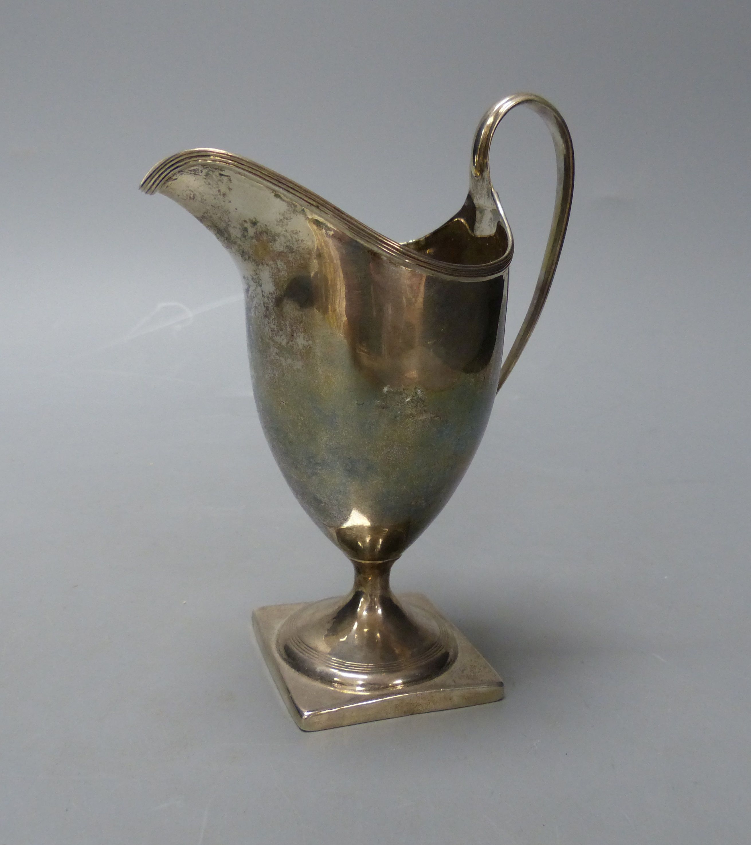 A George III silver helmet shaped cream jug, I.B, London, 1800, 14.9cm